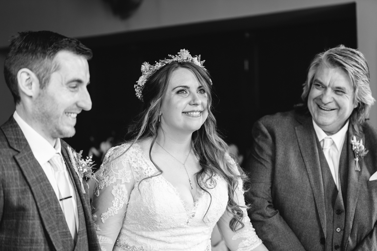 Bride, groom and father laughing