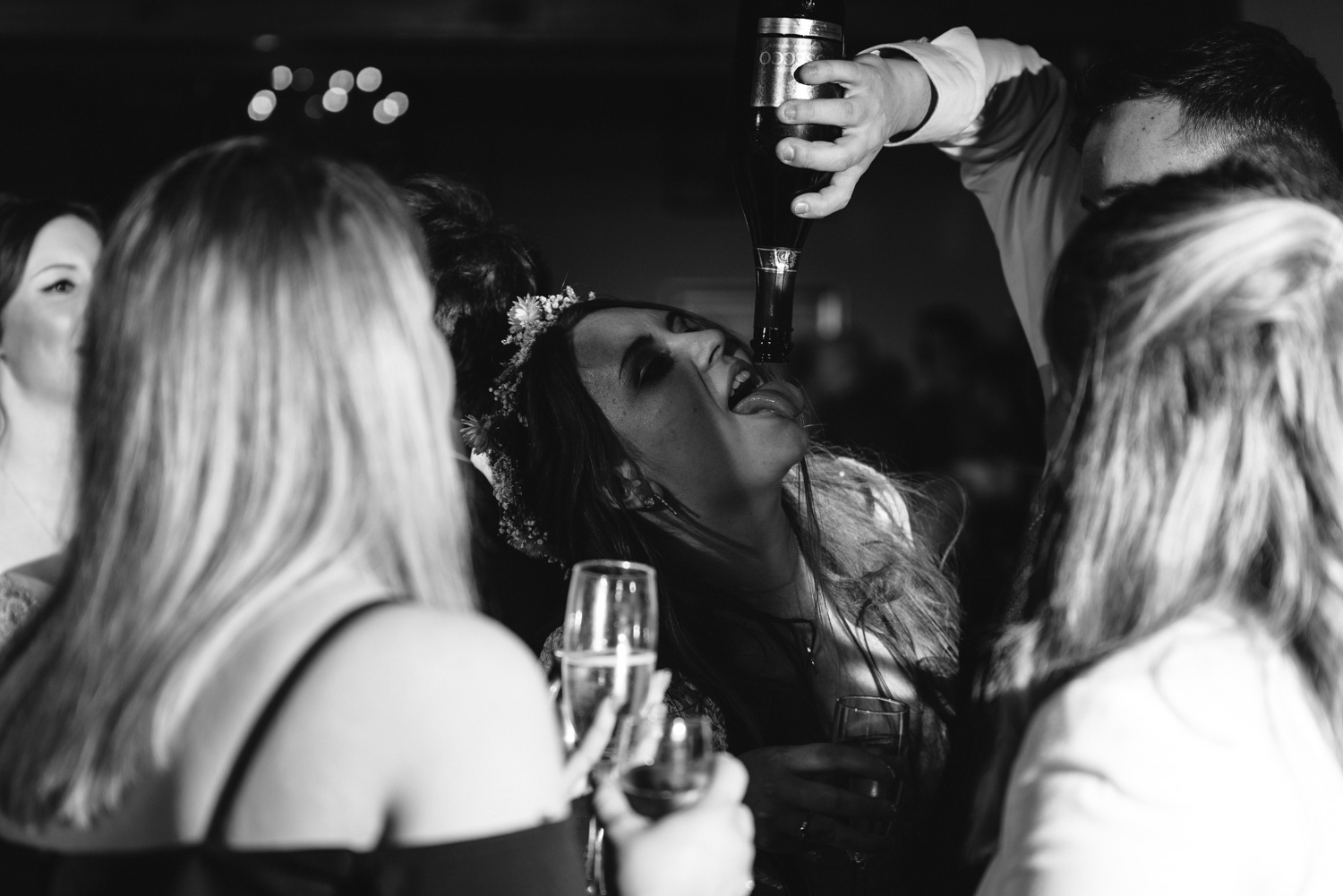 Bride drinking from bottle