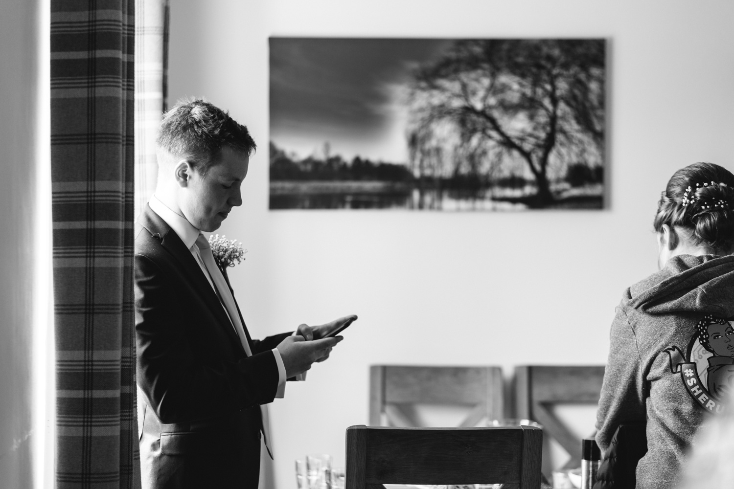Brides brother looking at phone