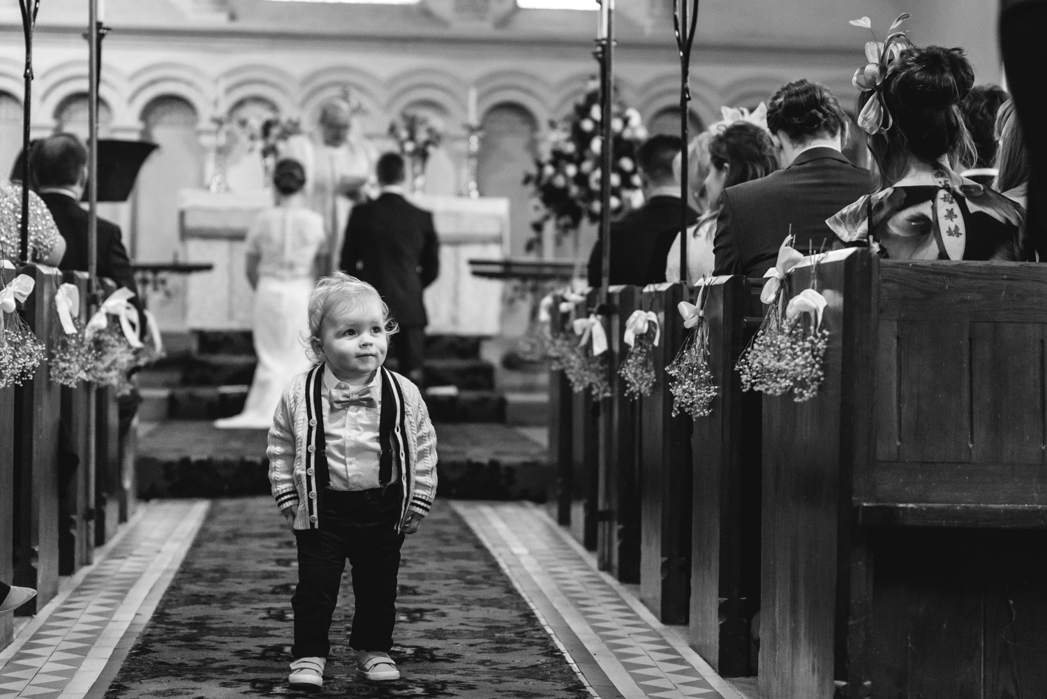 Toddler in church aisle during wedding