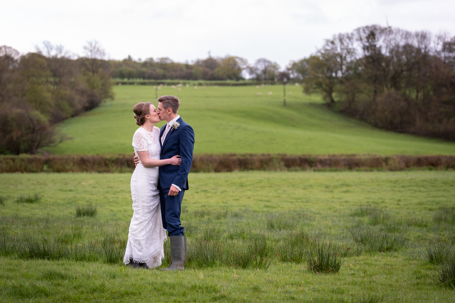 Bride and groom in field at wedding