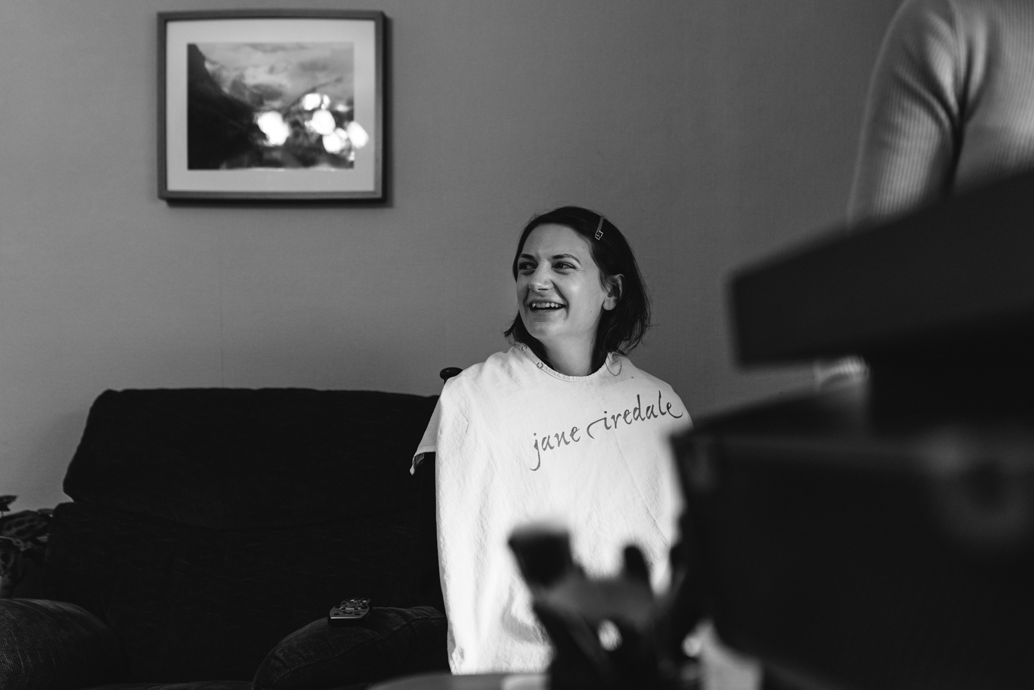 Bridesmaid laughing during make-up