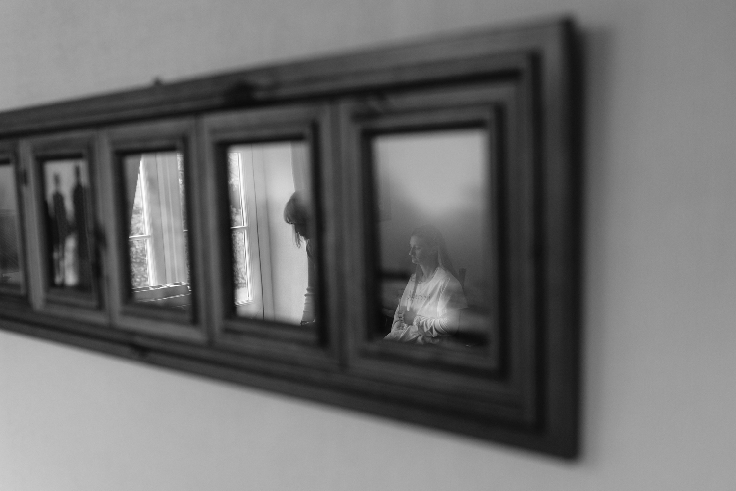 Brides reflection in photograph on wall