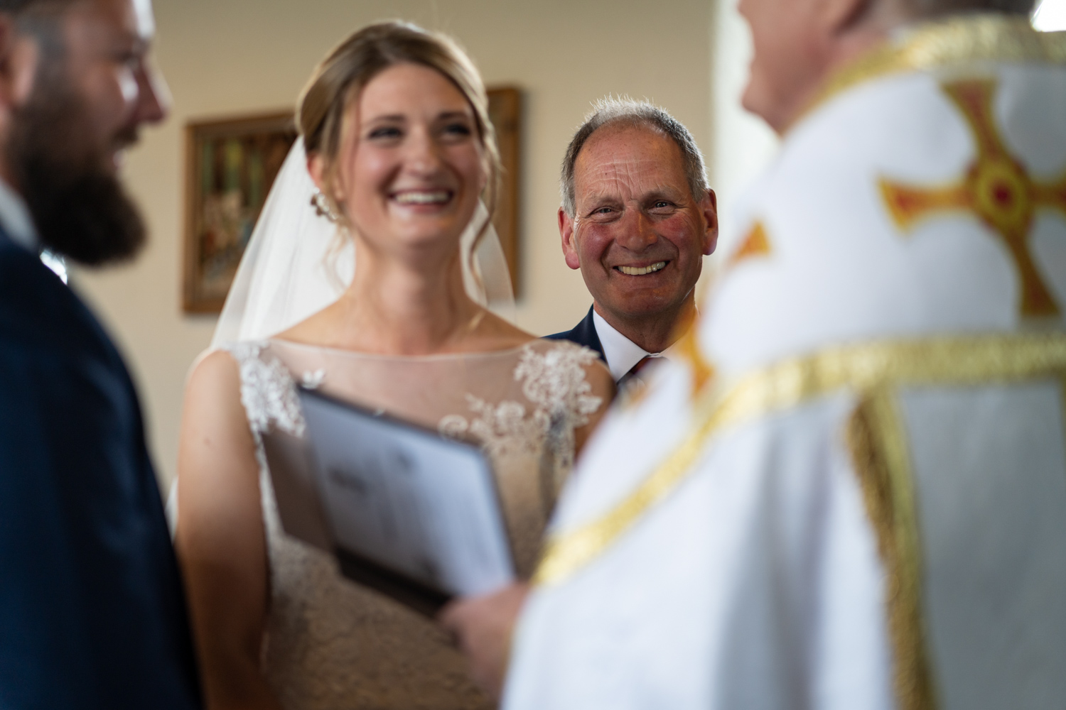 Bride and dad laughing during wedding