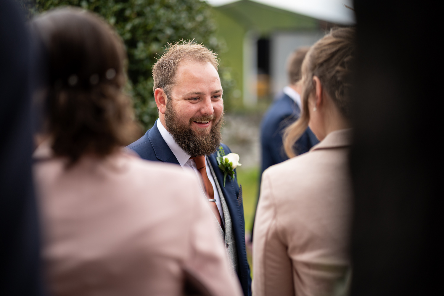 Groom talking to guests outside church