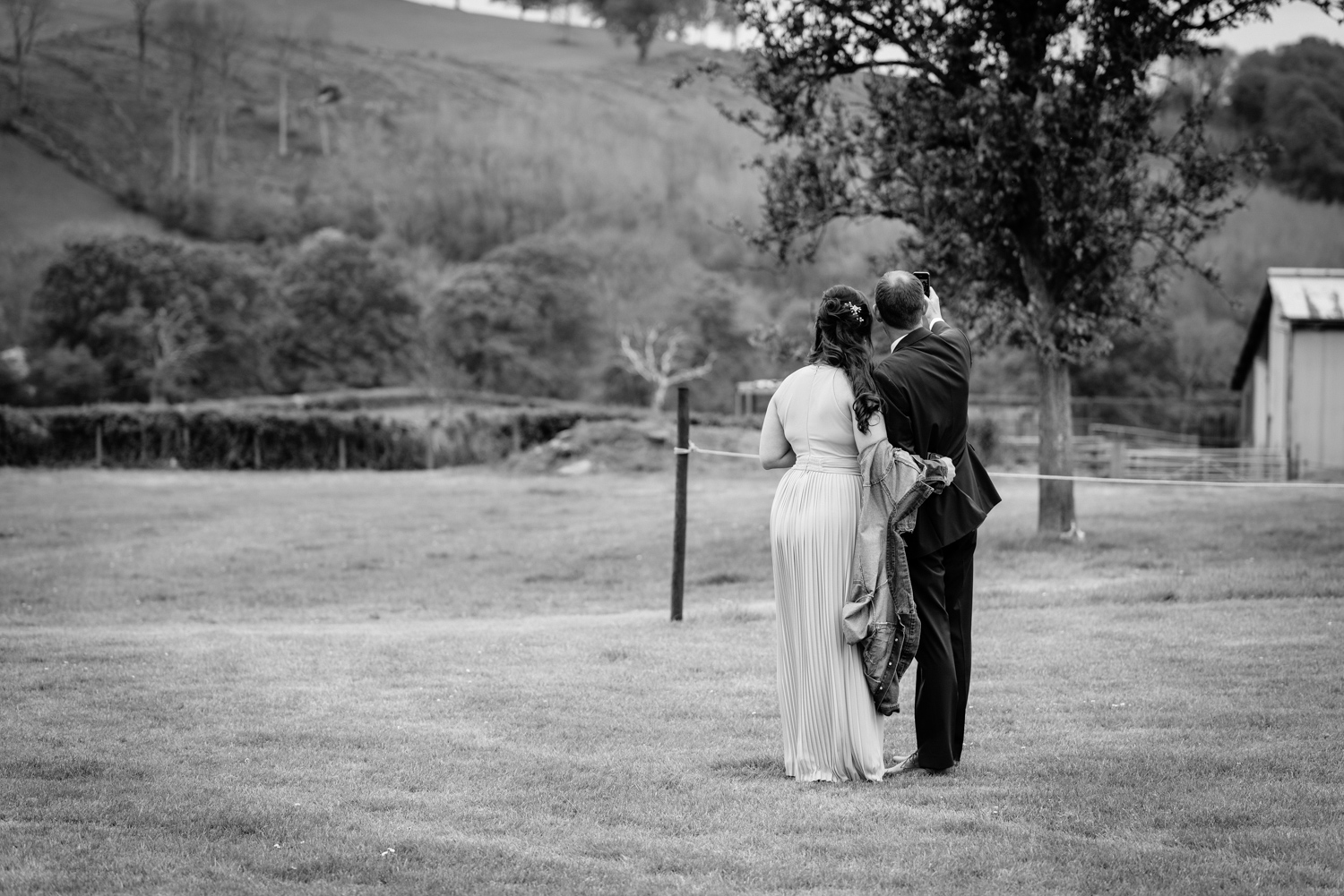 Bridesmaid and usher taking selfie