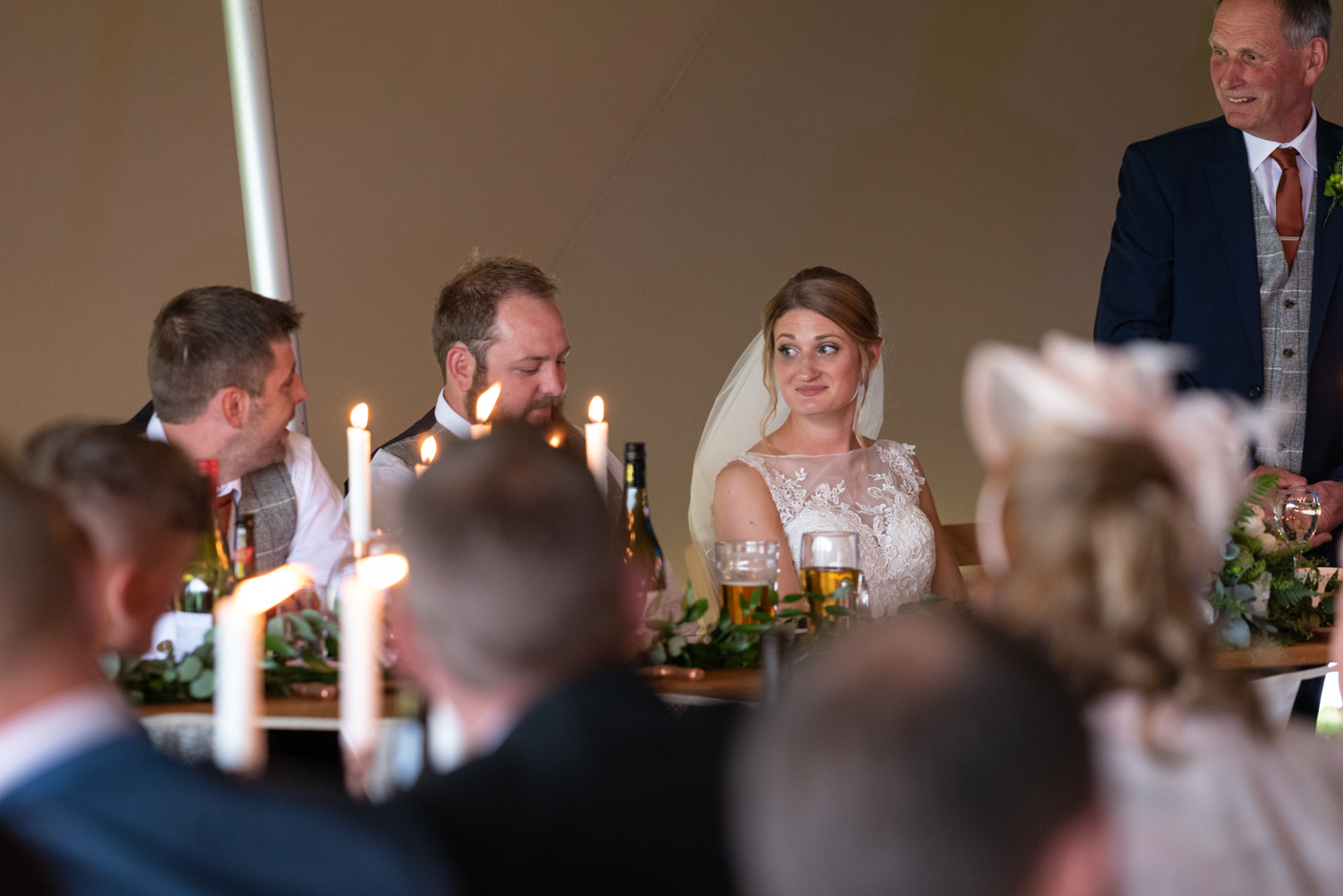 Bride looking at groom during speeches
