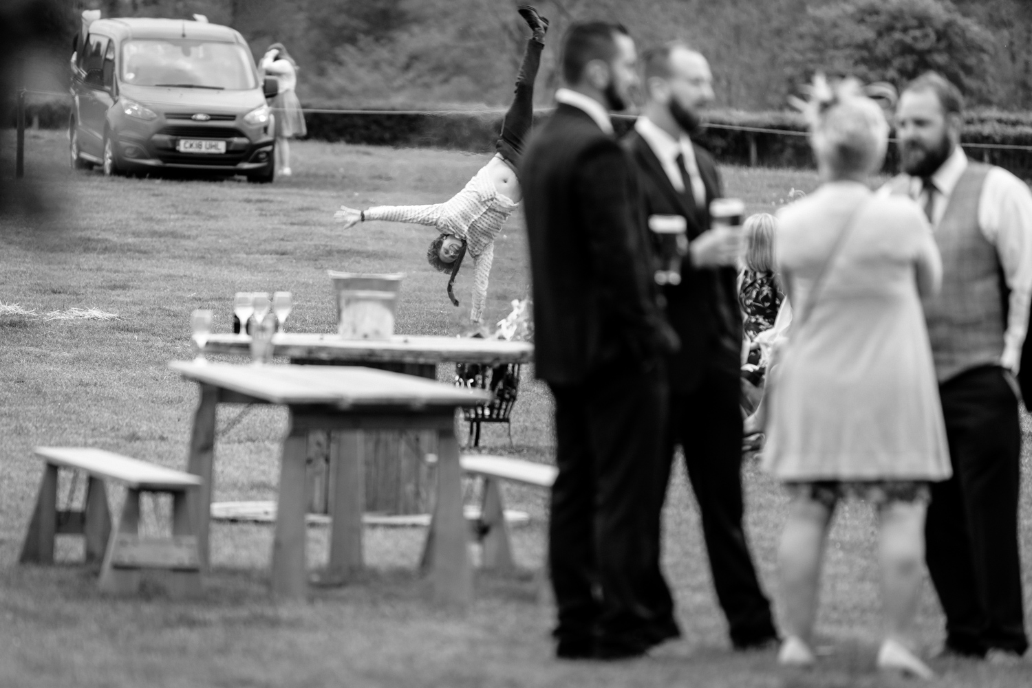 Man doing cartwheel at wedding