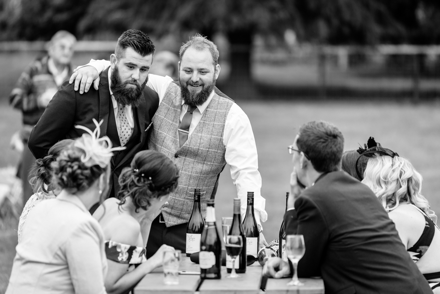 Groom with arm around mate