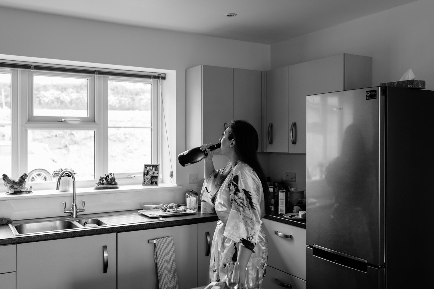 Bride drinking Champagne from bottle