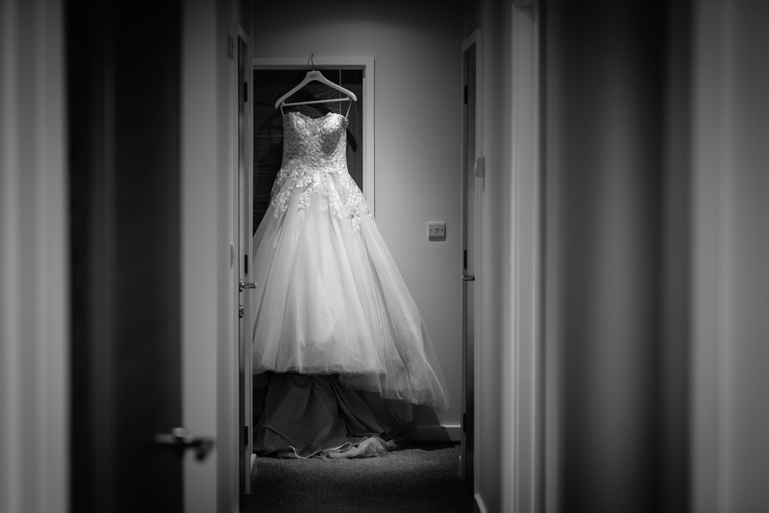Wedding dress hanging in doorway