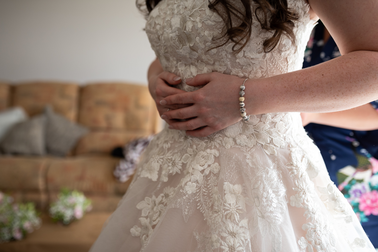 Brides hands on dress