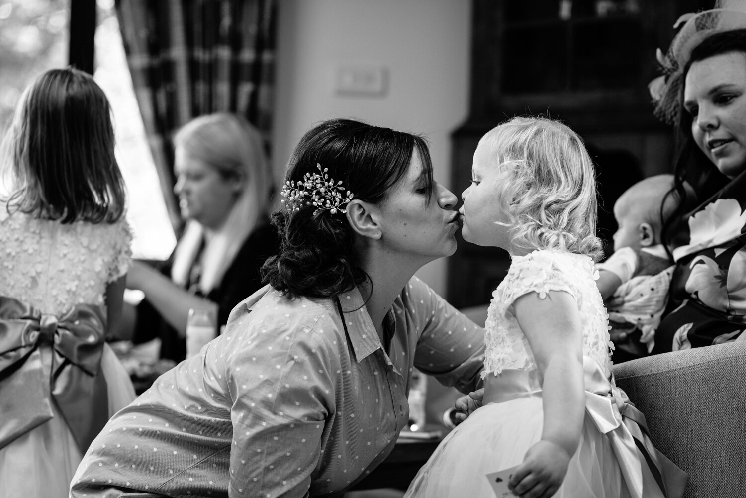 Bride and flower girl kissing