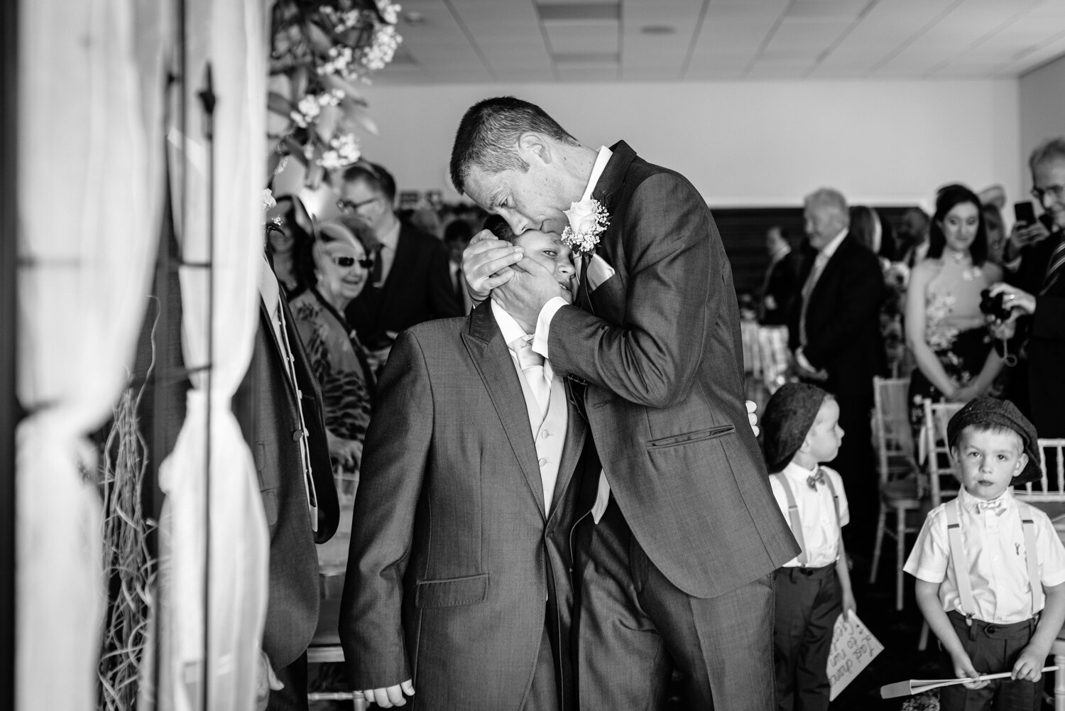 Groom and brides son embrace