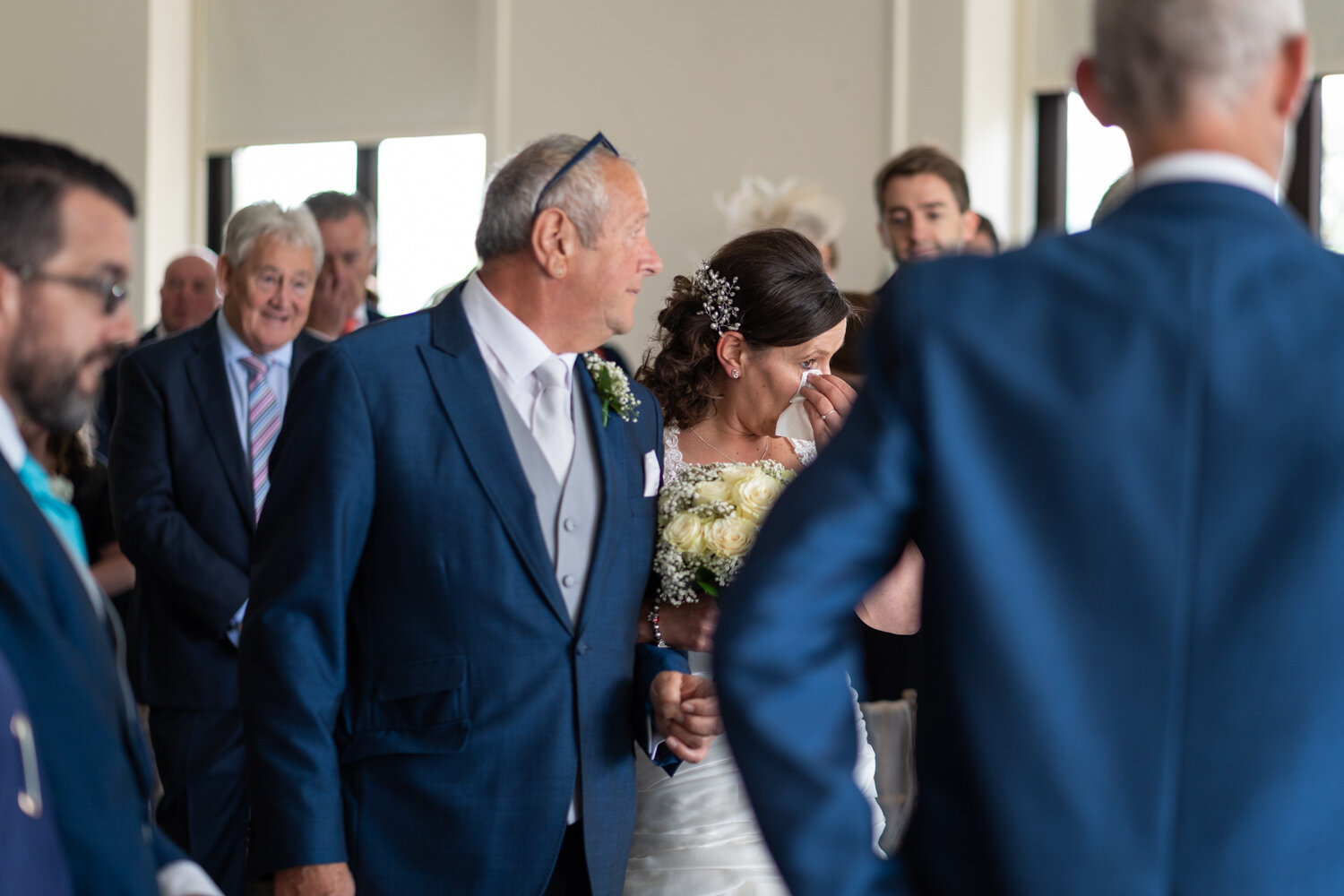 Bride crying with dad walking down the aisle