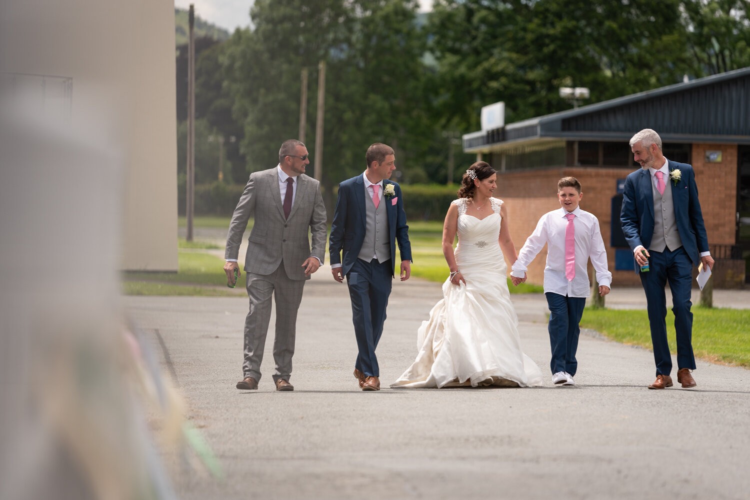 Bride, groom and guests walking to ceremony