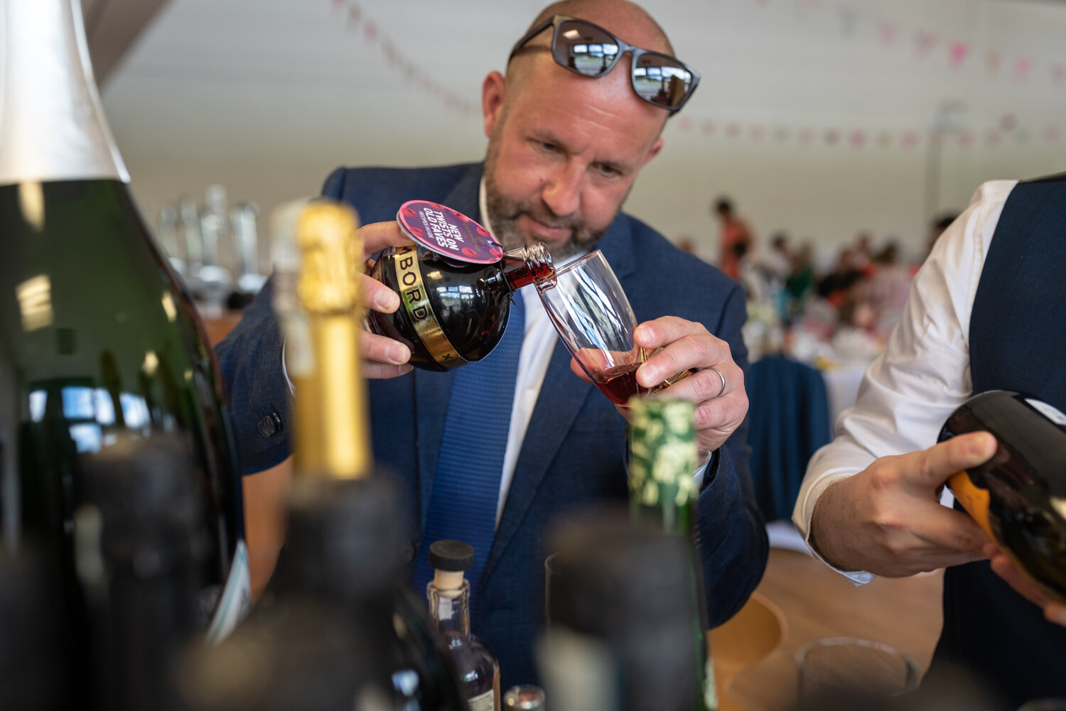 Wedding guest pouring a drink