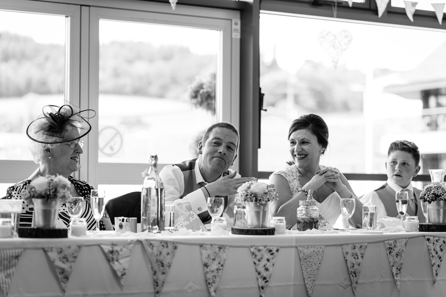 Bride laughing at groom during wedding speeches