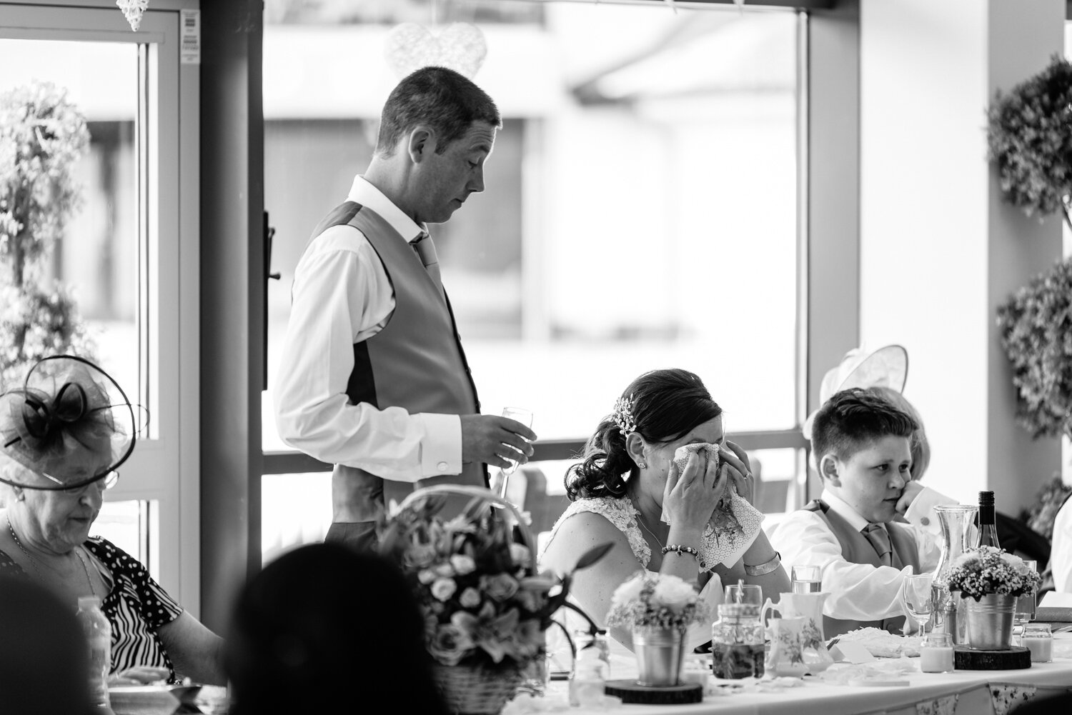 Bride with head in hands during speeches