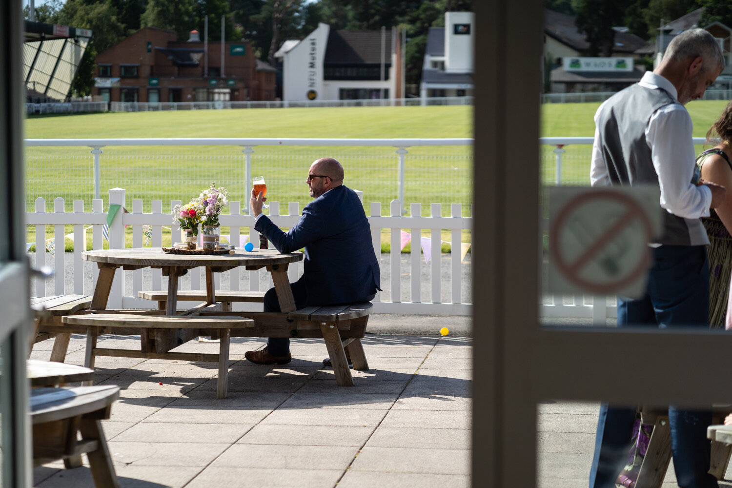 Wedding guest admiring his beer