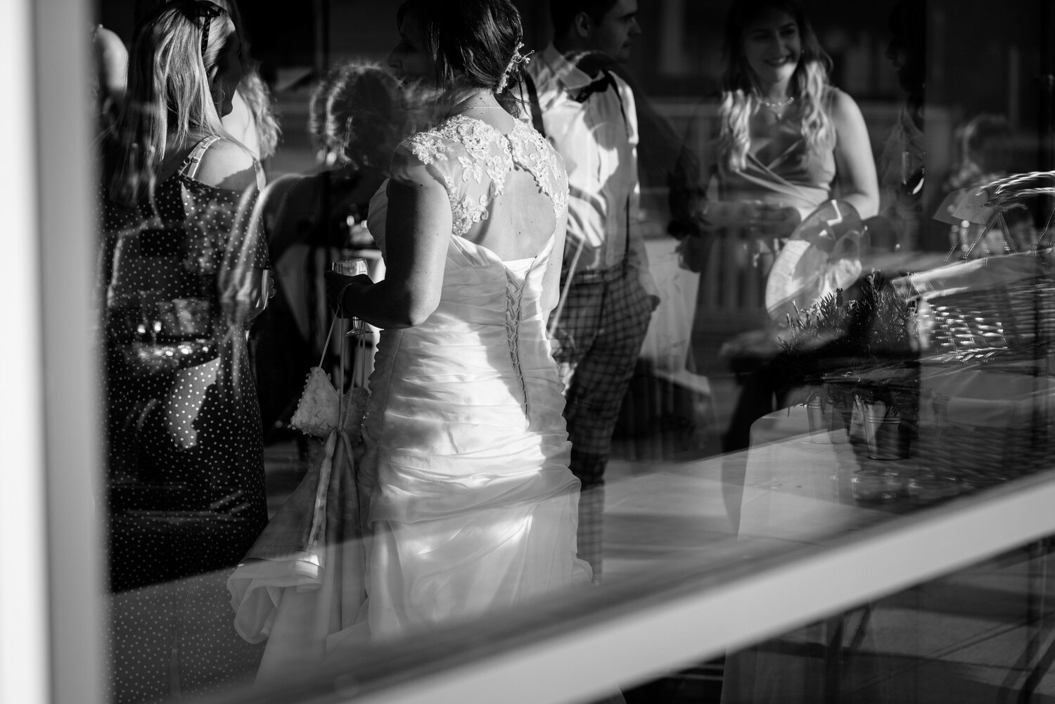 Reflection of brides dress in window 