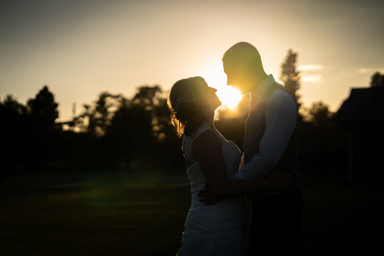 Sunset silhouette of bride and groom