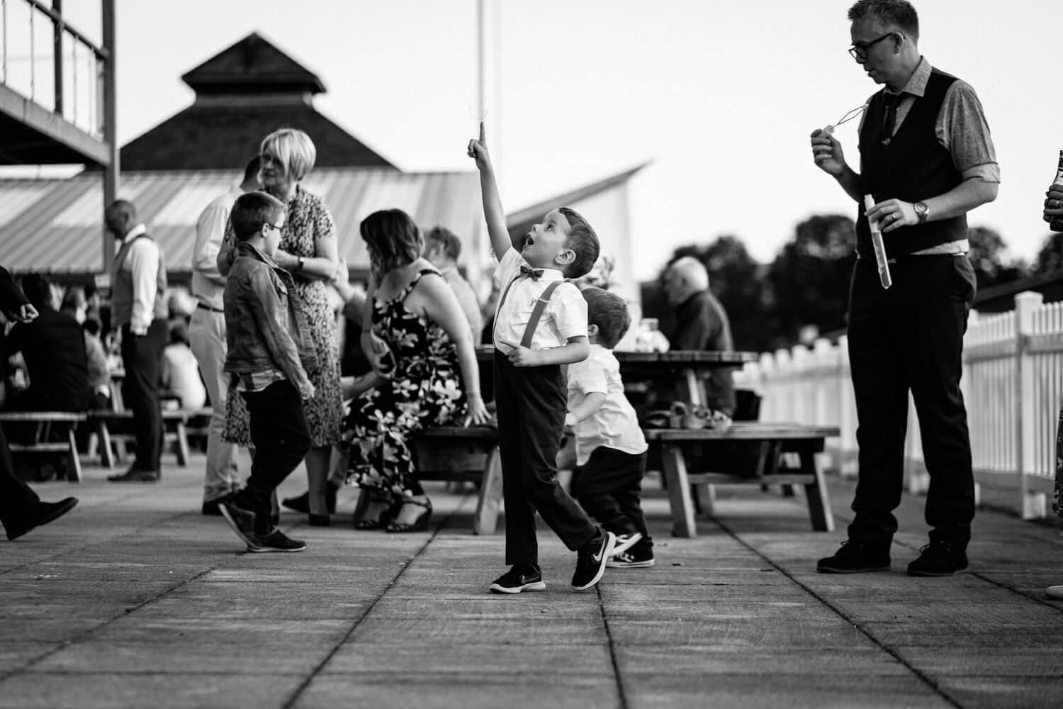 Children playing at wedding popping bubbles
