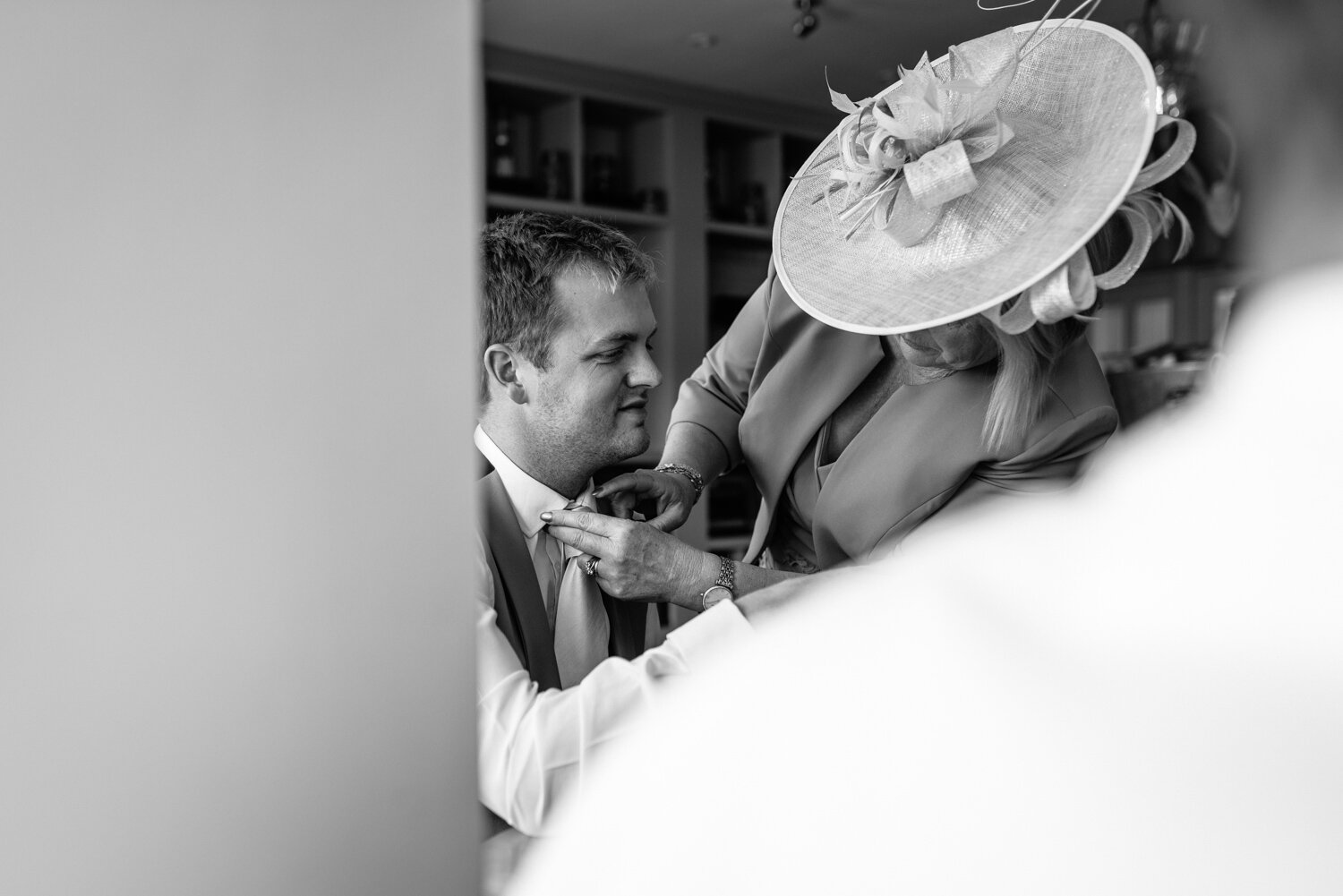 Grooms mother sorting grooms tie