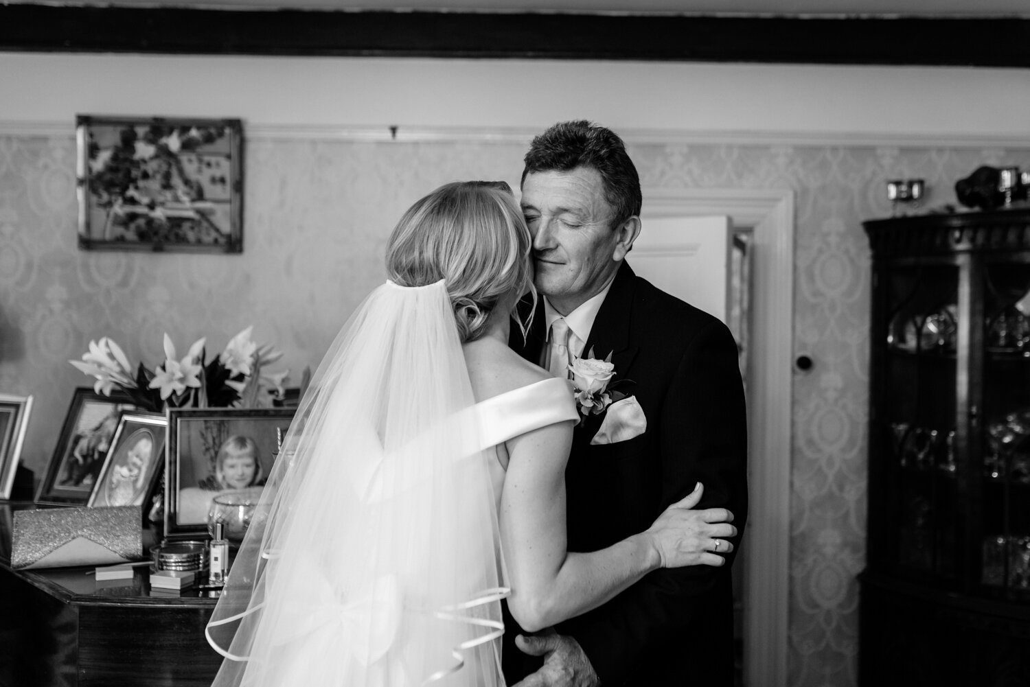 Bride and father hugging