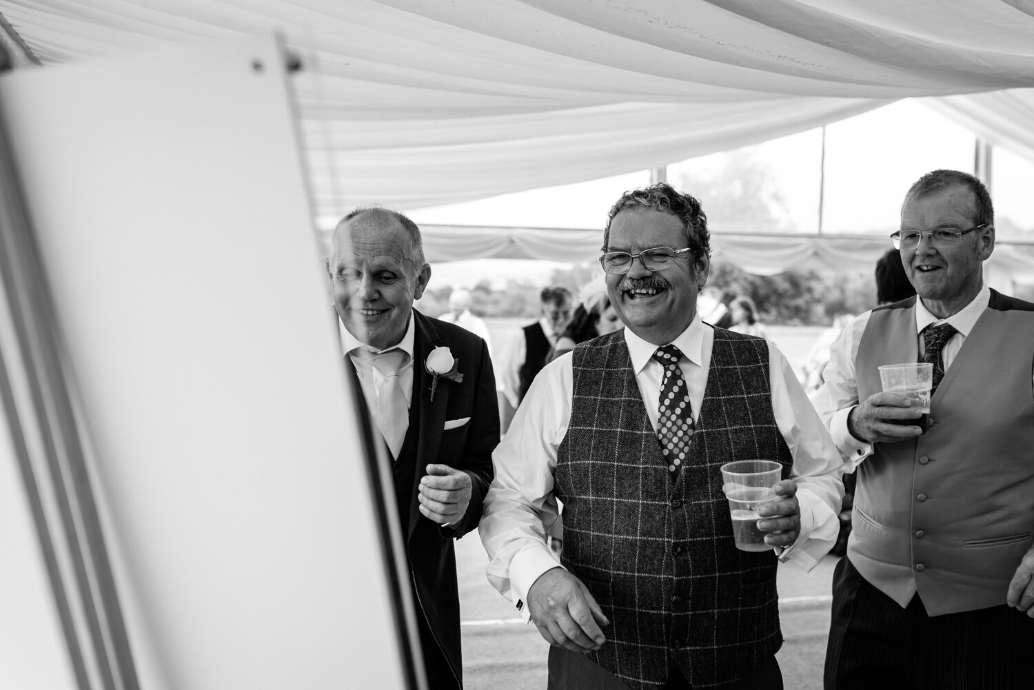 Wedding guests laughing at Powys wedding