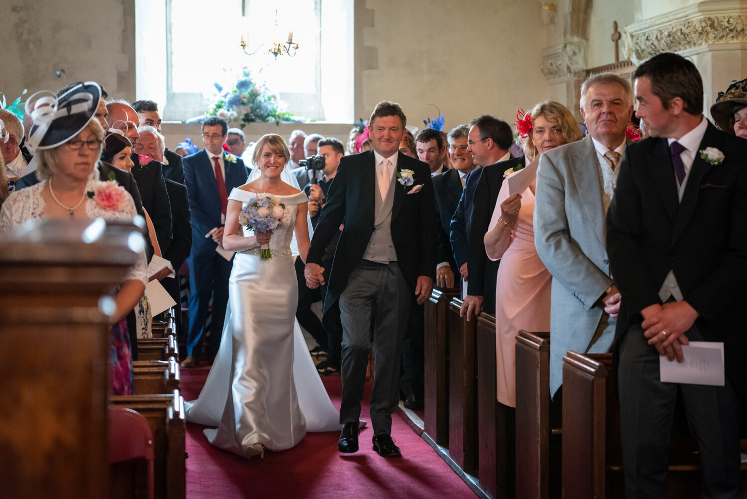 Powys wedding bride walking down aisle in Glasbury