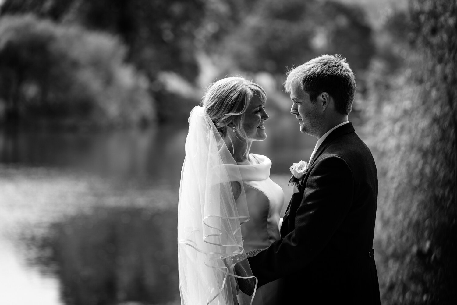 Groom with bride next to river Wye