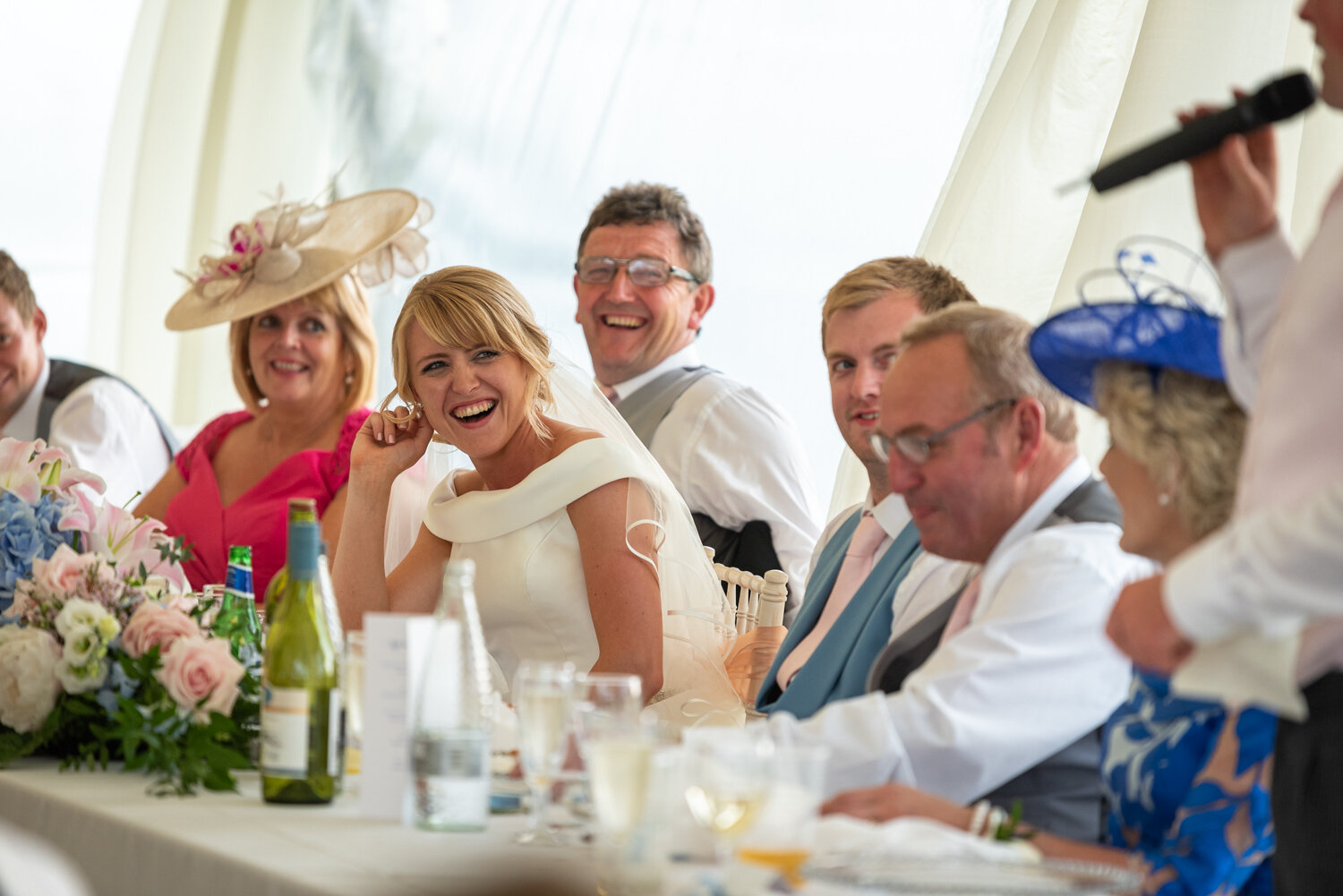 Sam laughing at speeches during her Powys wedding