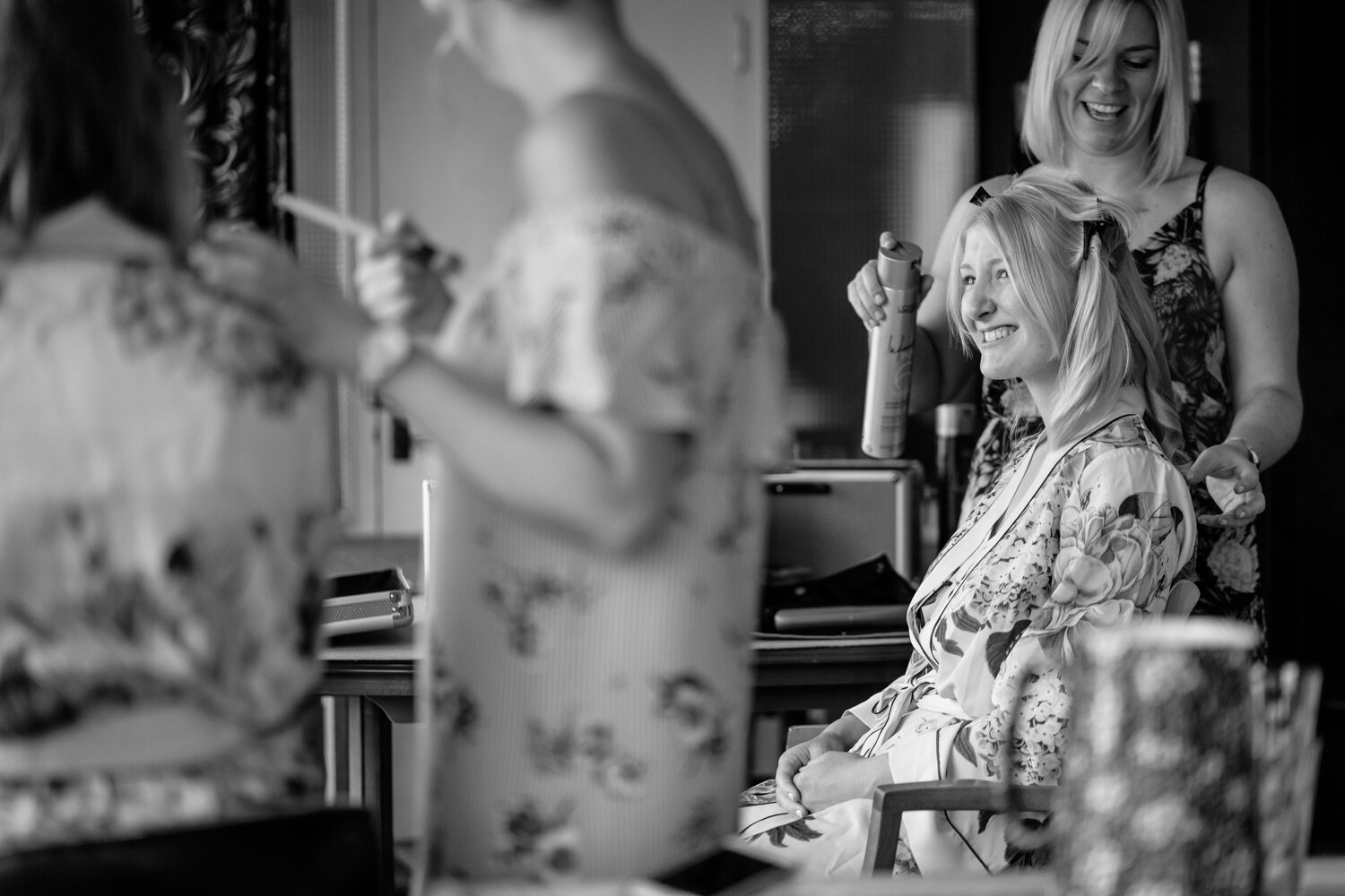 Bridesmaid smiling at bridal prep