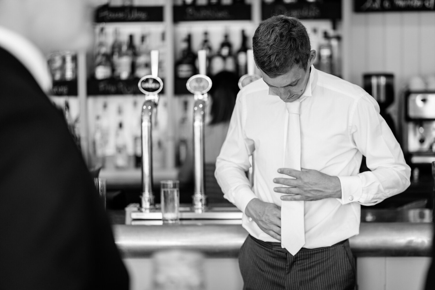 Best man checking tie