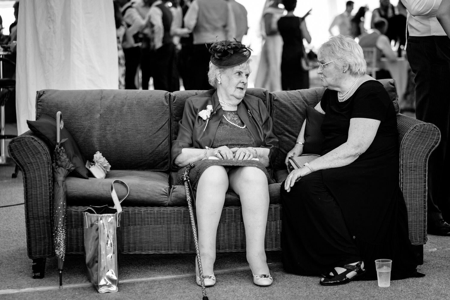 Two older wedding guests talking
