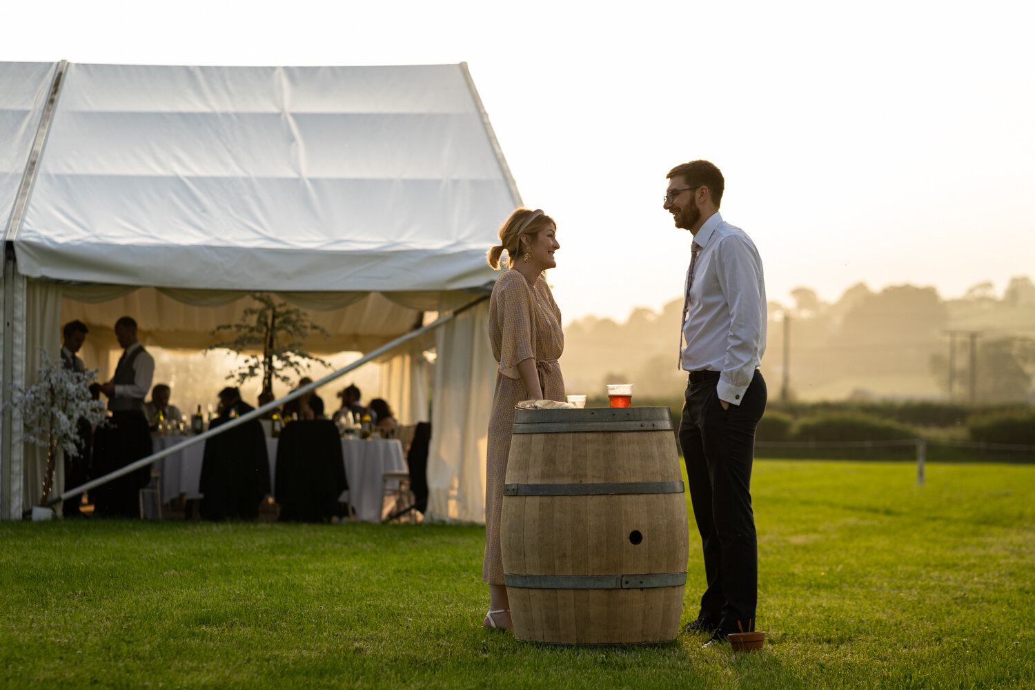 Wedding guests talking outside during wedding evening