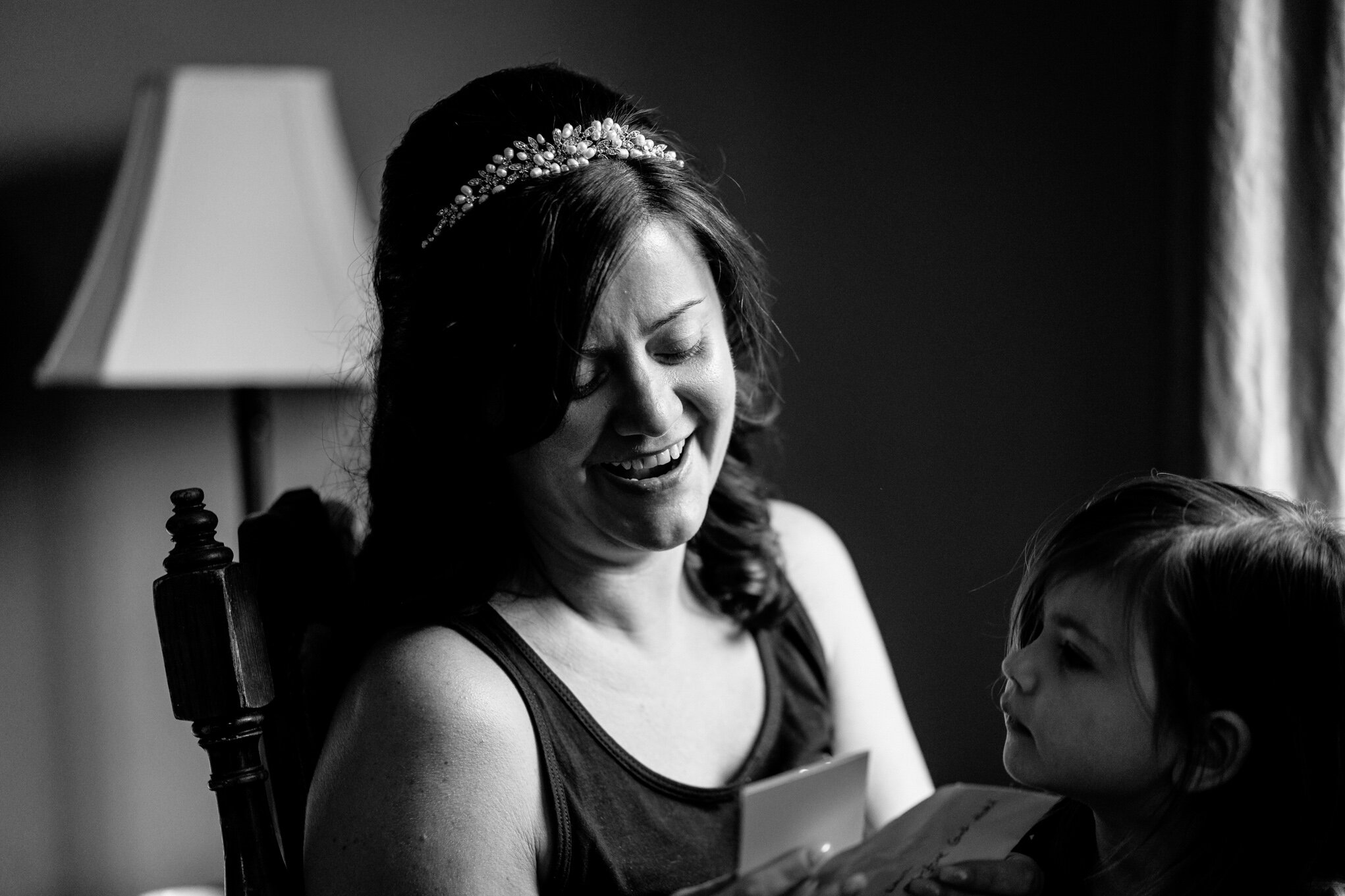 Bride laughing whilst reading card