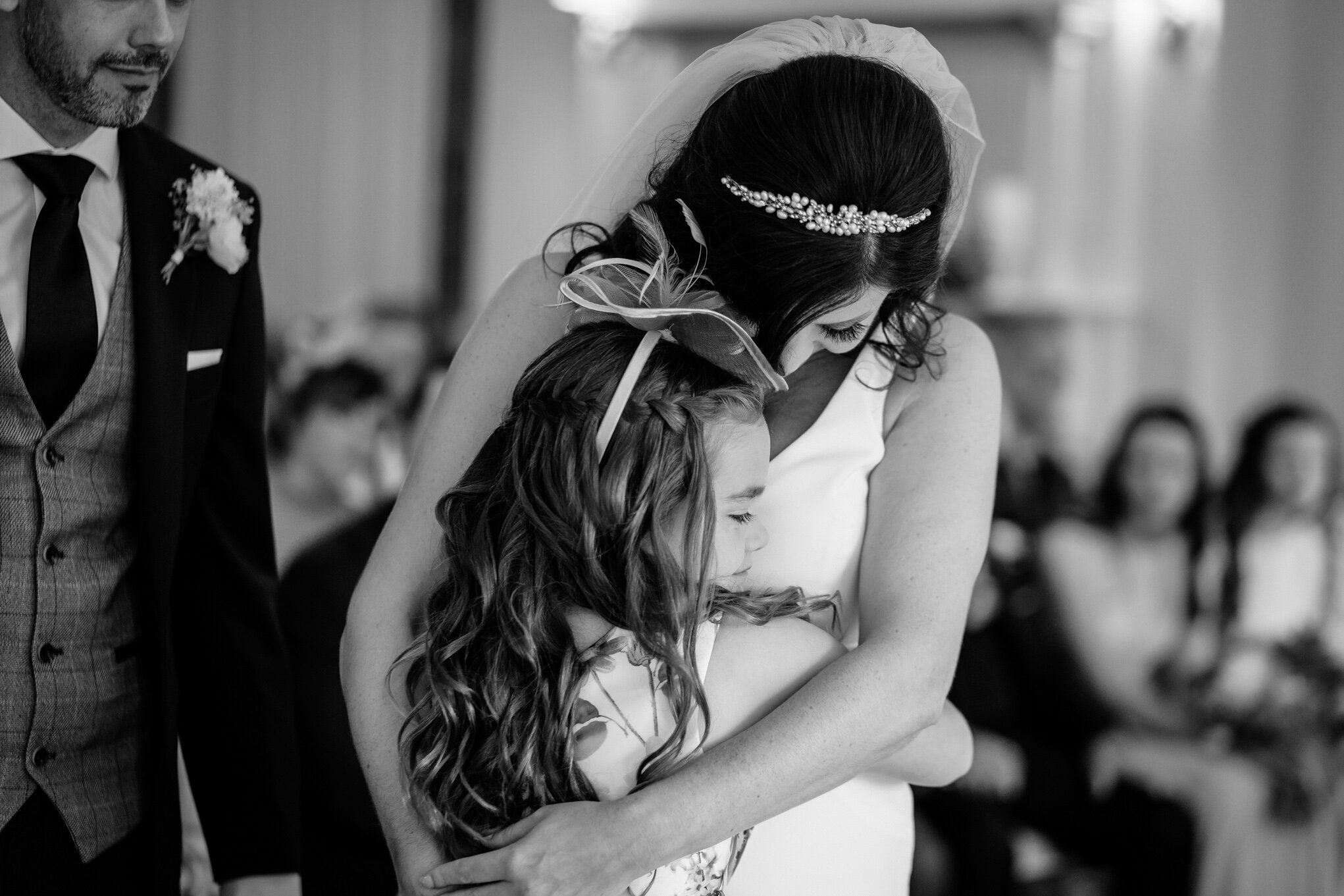 Bride hugging young girl