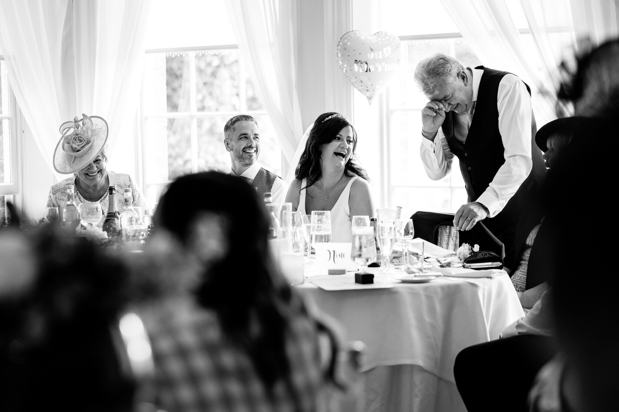 Father of bride laughing during his speech