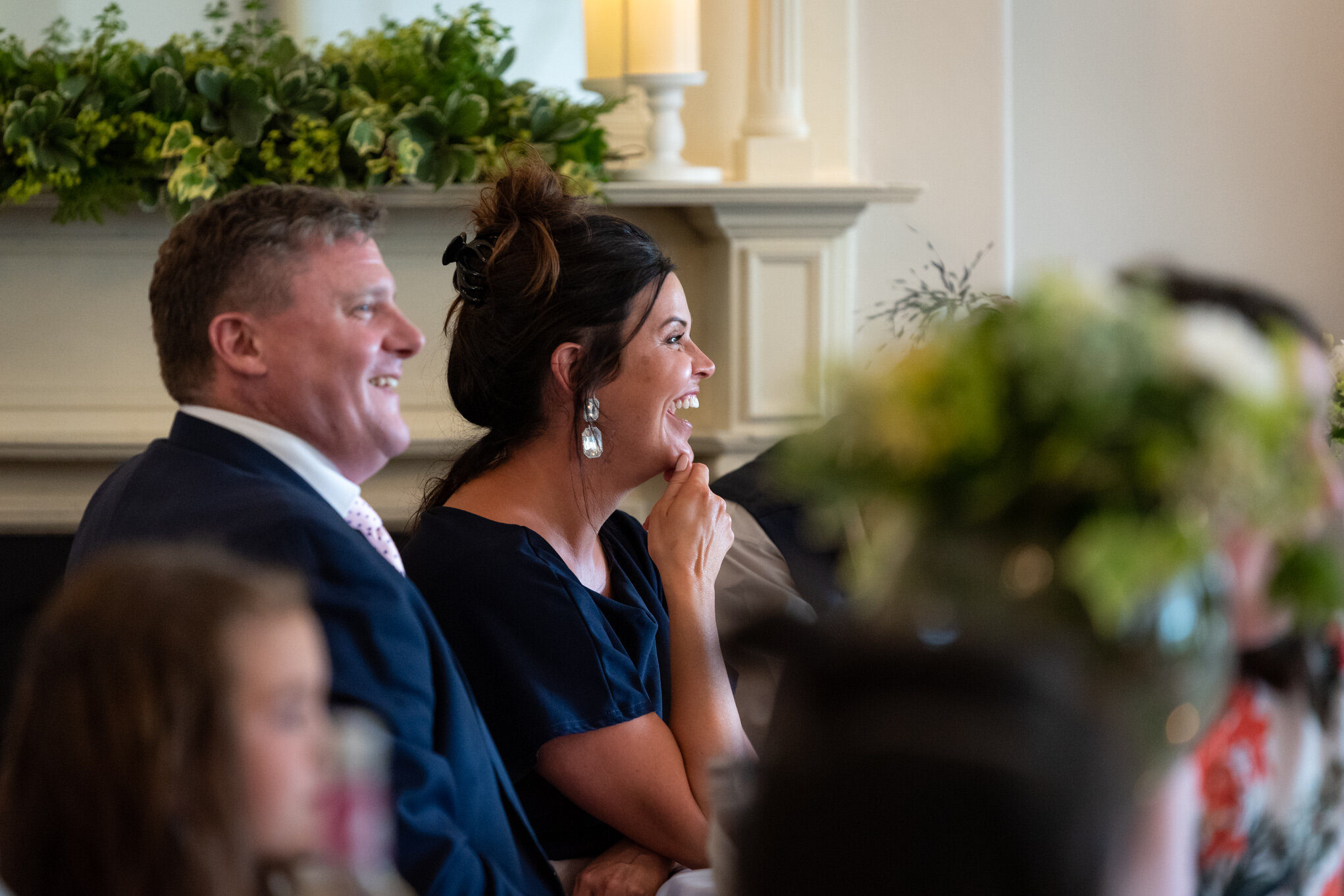 Guests laughing wedding speeches