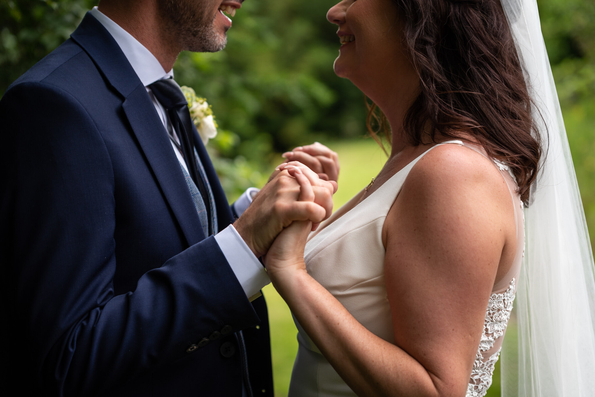 Bride &amp; groom holding hands at Peterstone Court