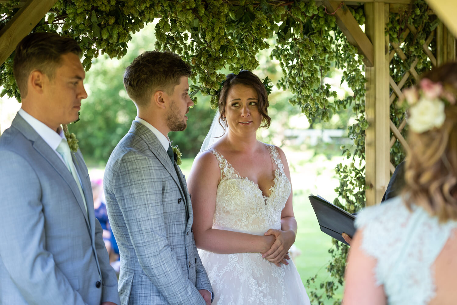 Bride looking at groom during Tall John's House outdoor wedding ceremony