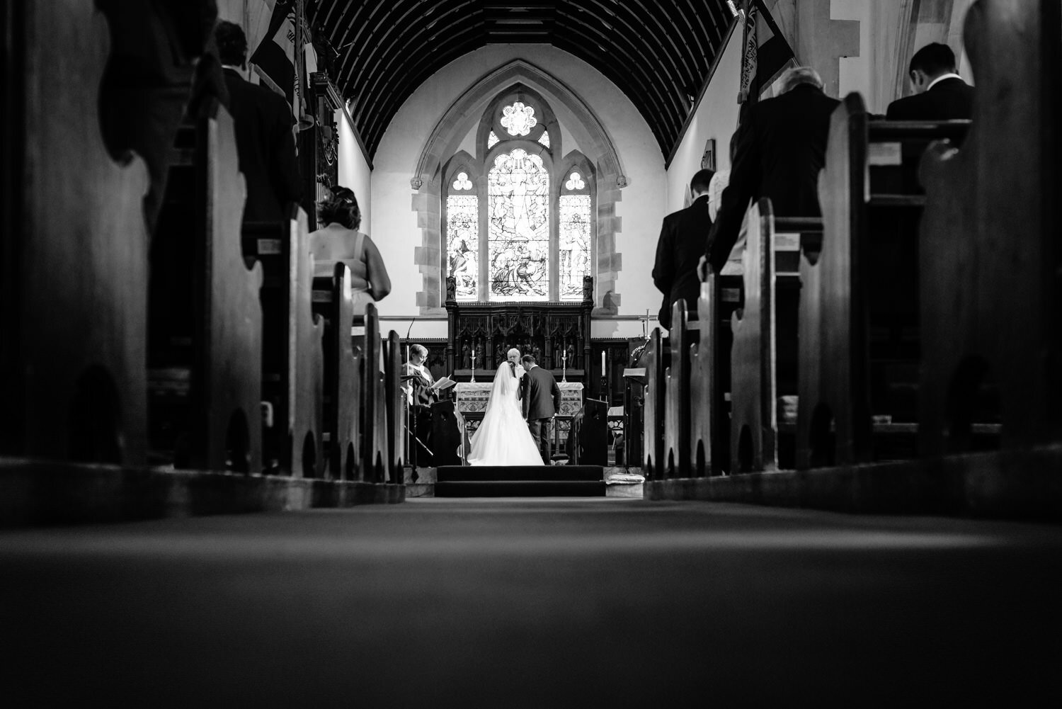 Bride &amp; Groom kneeling at the altar during wedding