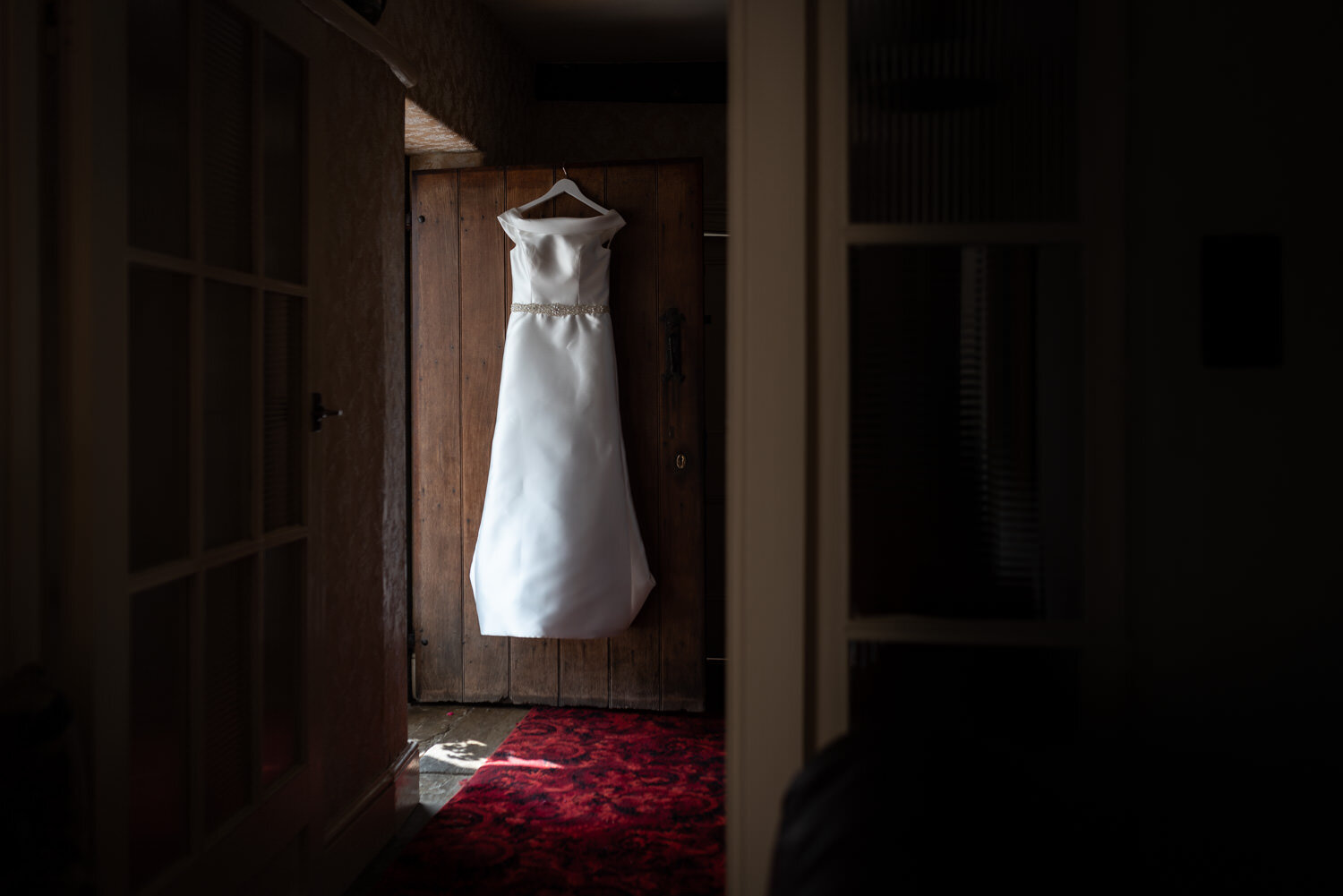 Wedding dress hanging in door