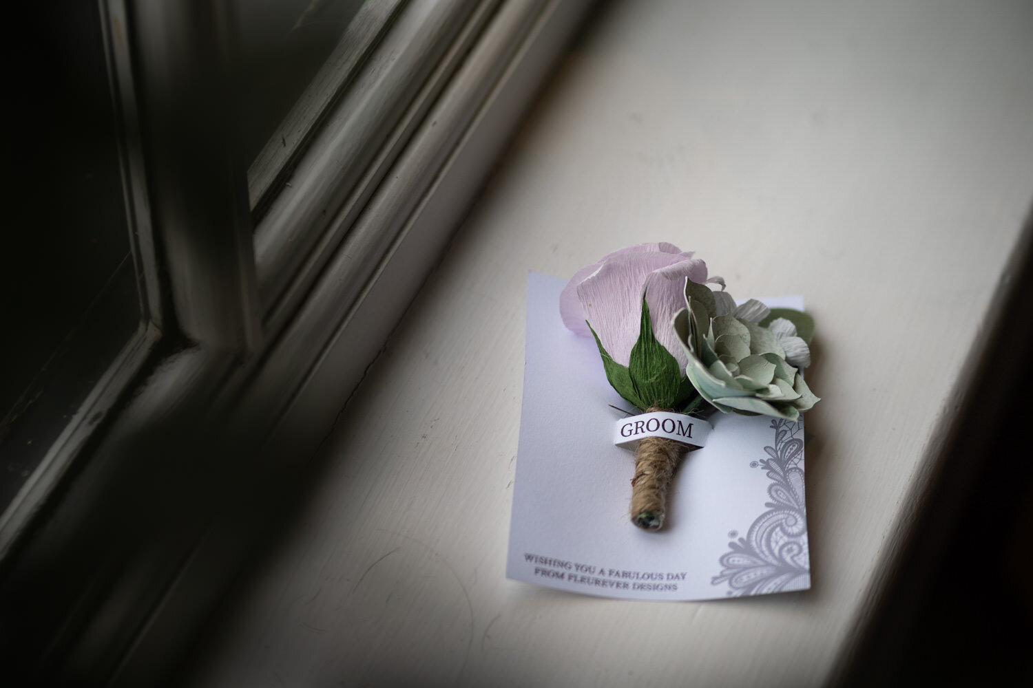 A paper buttonhole flower for the groom 