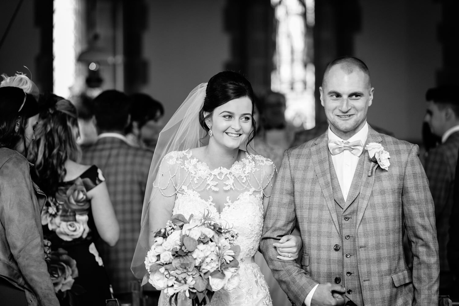 Bride and groom walking out of church