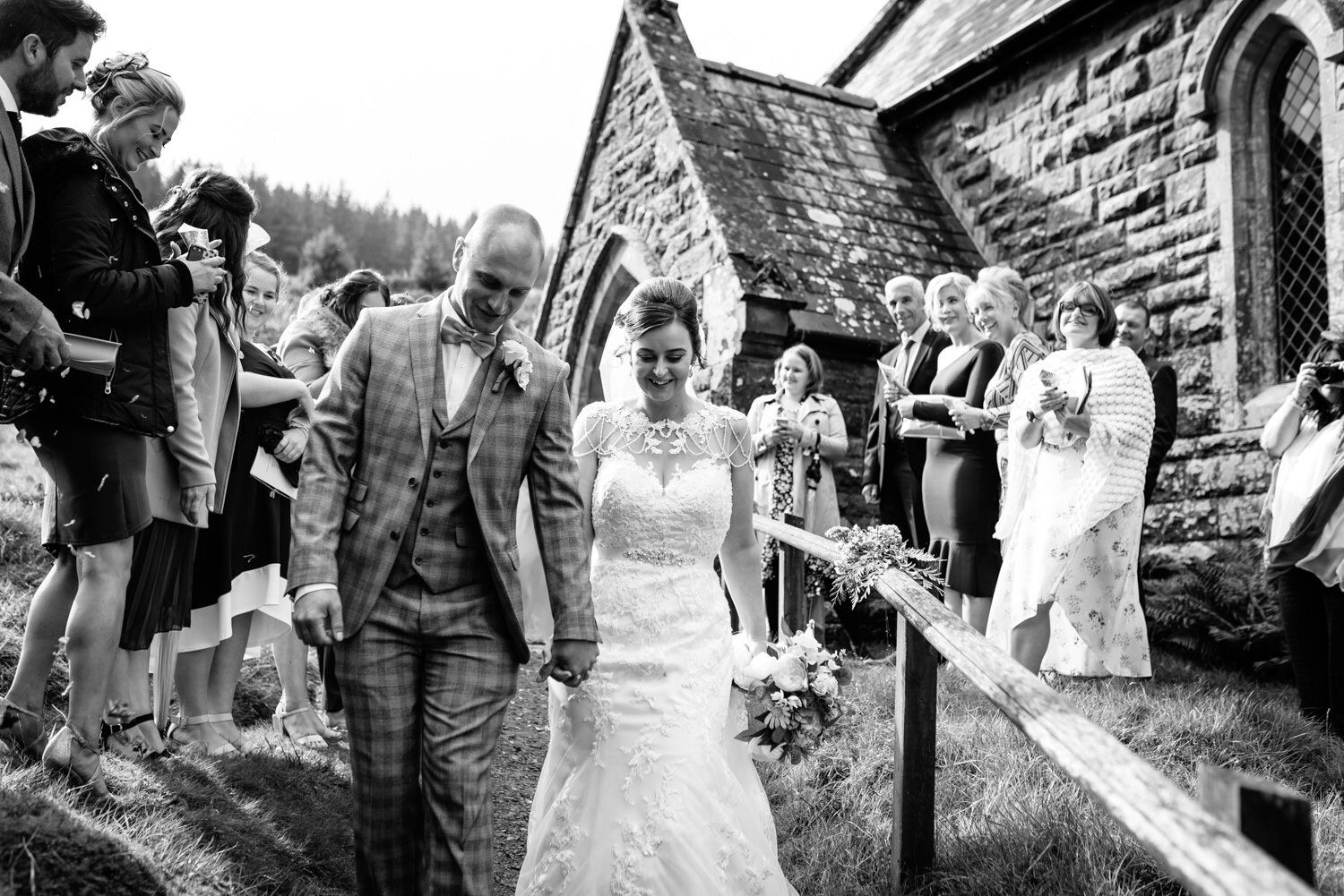 Bride and groom walking from Powys wedding at Elan Valley church