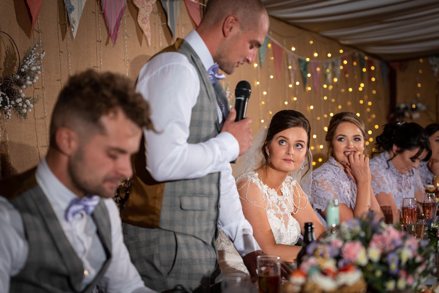 Bride looking at groom during speeches at Powys wedding
