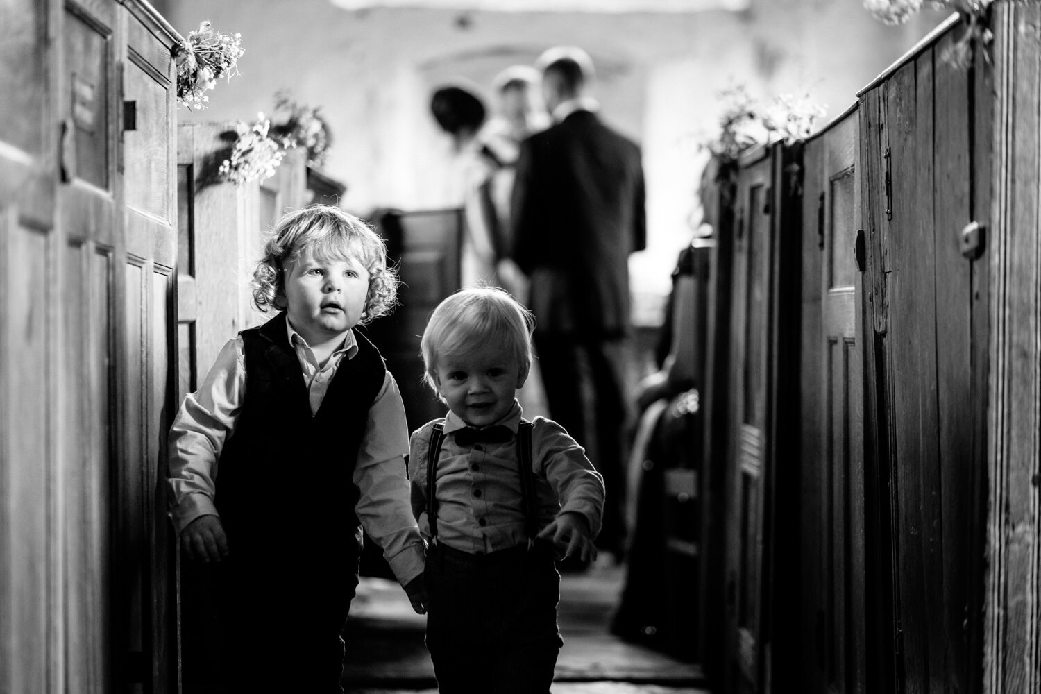 Children playing in the aisle during wedding